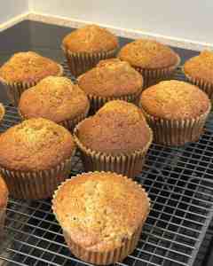 Delicious homemade muffins cooling, perfect for breakfast or snack. Fresh baked muffins with golden crust.