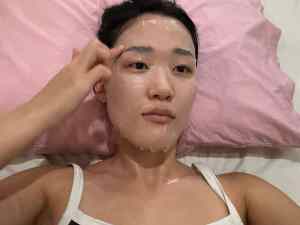 Close-up of Rare floral peony blossom fragrance layering balm in soft pink tube with minimalist design.