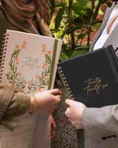 two women holding 2026 Planners Australia