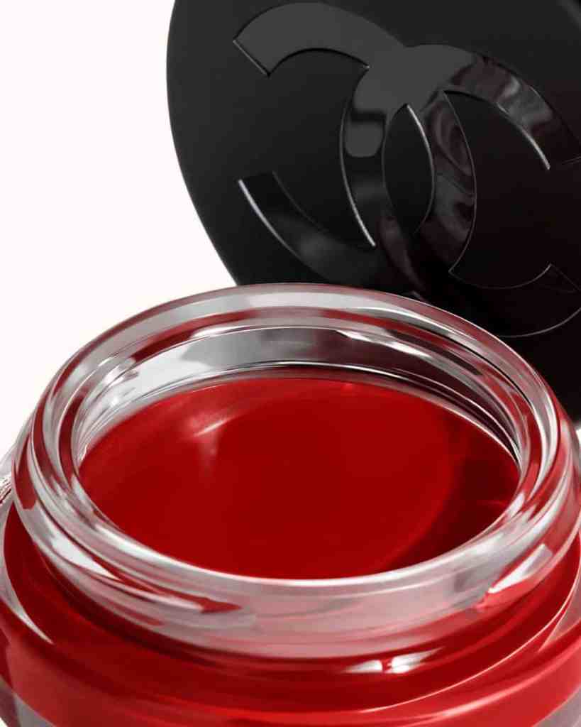 Luxury lip gloss from Chanel with rich red pigmentation in a sleek glass jar.