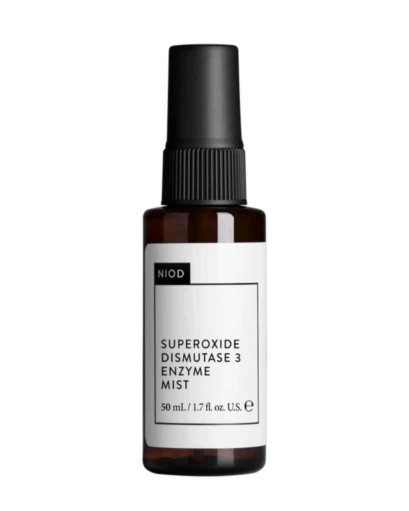 Black spray bottle with white label for skincare enzyme mist.