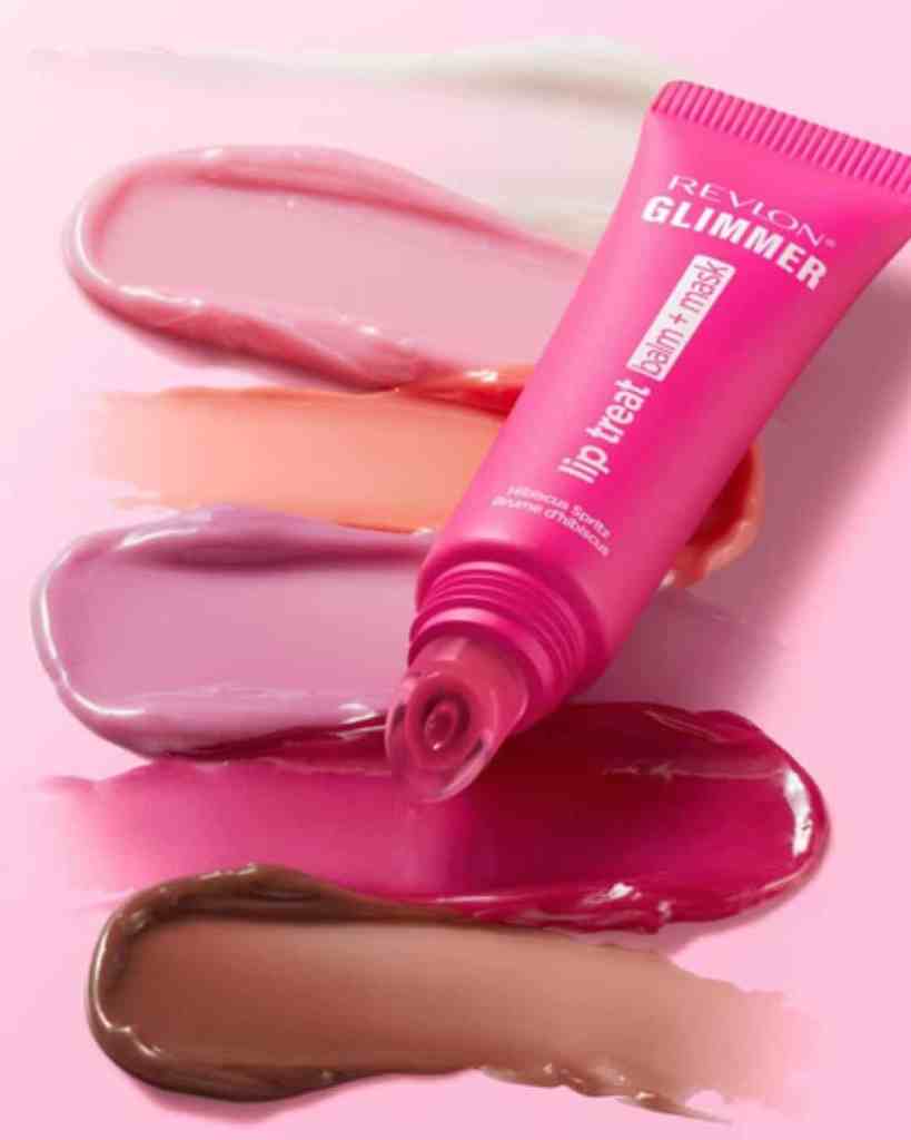 Vibrant pink Revlon lip gloss treatment with multiple colour swatches on pink surface for enhanced lips and beauty.