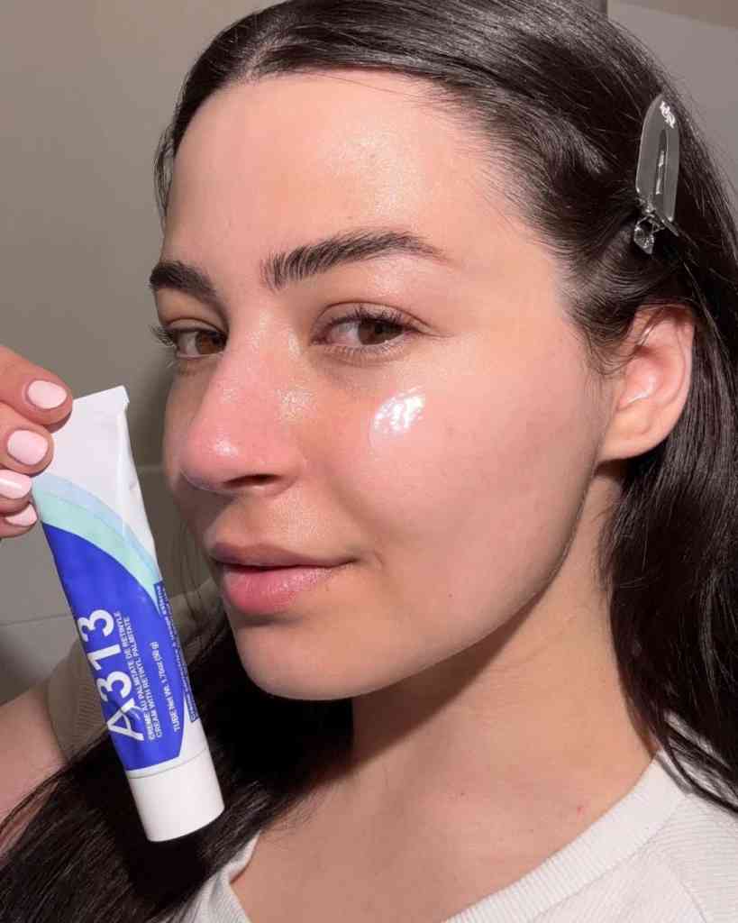 A woman applying skincare product for clear, radiant skin, showcasing skincare routines.