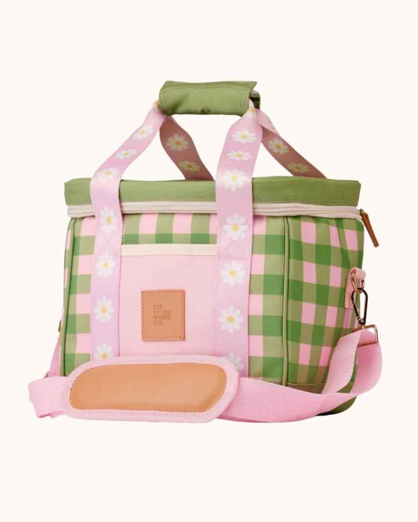 Bright insulated cooler bag with checks, daisies, and adjustable shoulder strap for outdoor use.