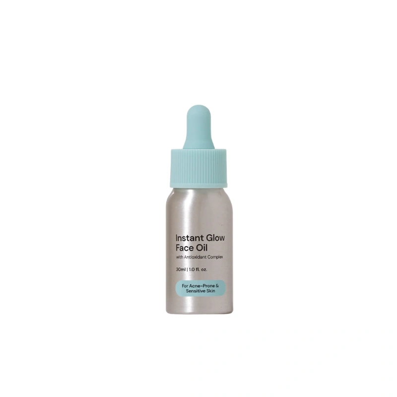 Conserving beauty facial oil for combination skin in a silver bottle with a blue cap, on a white background.