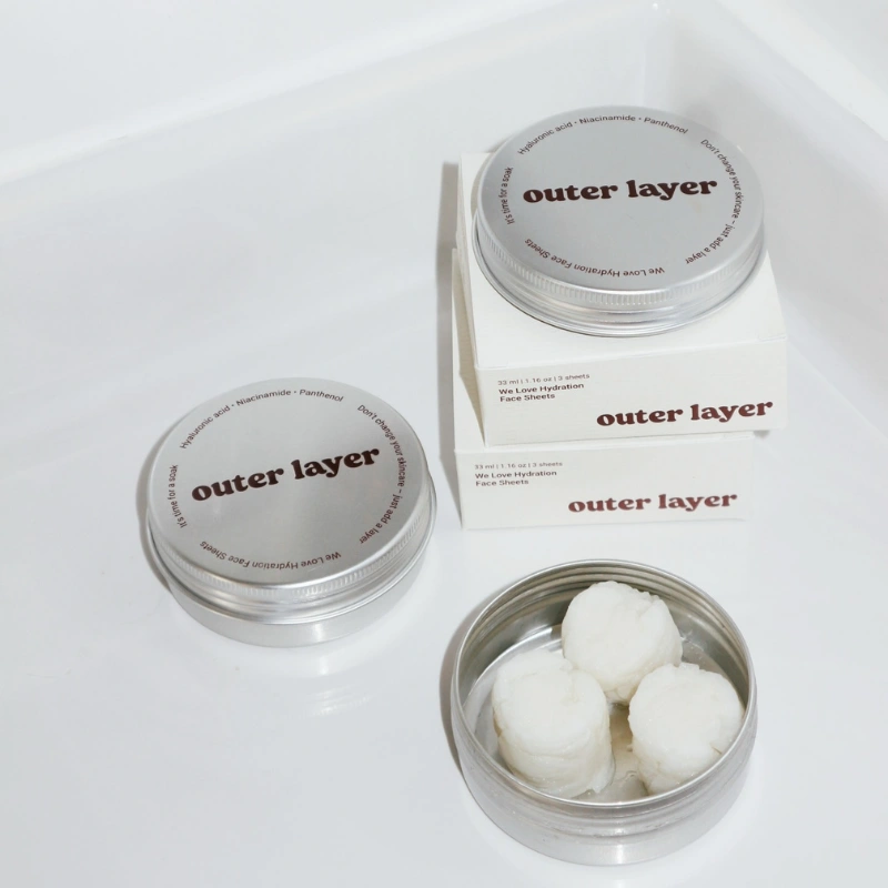 Outer Layer sheet masks in aluminum tins.